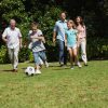 Happy multi generation family playing football